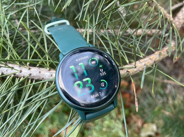 The Garmin vívoactive 6 smartwatch lying over the branch of a tree